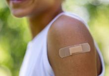 child smiles after receiving a COVID-19 vaccination shot